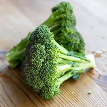 Close-up of fresh broccoli on a wooden table, emphasizing healthy eating.