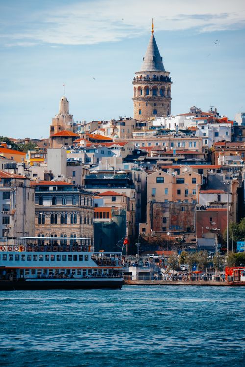 Free Scenic view of Galata Tower and vibrant architecture by the waterfront in Istanbul, Turkey. Stock Photo