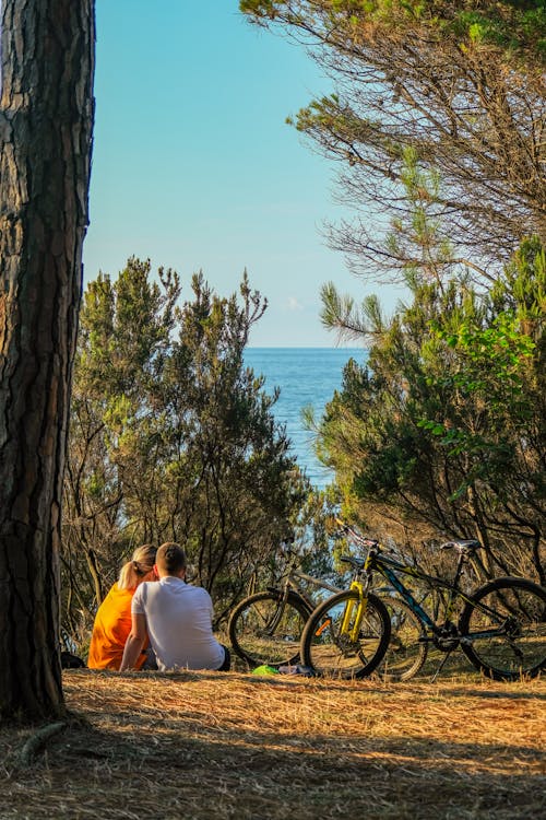 Couple Sitting Beside Their Bikes