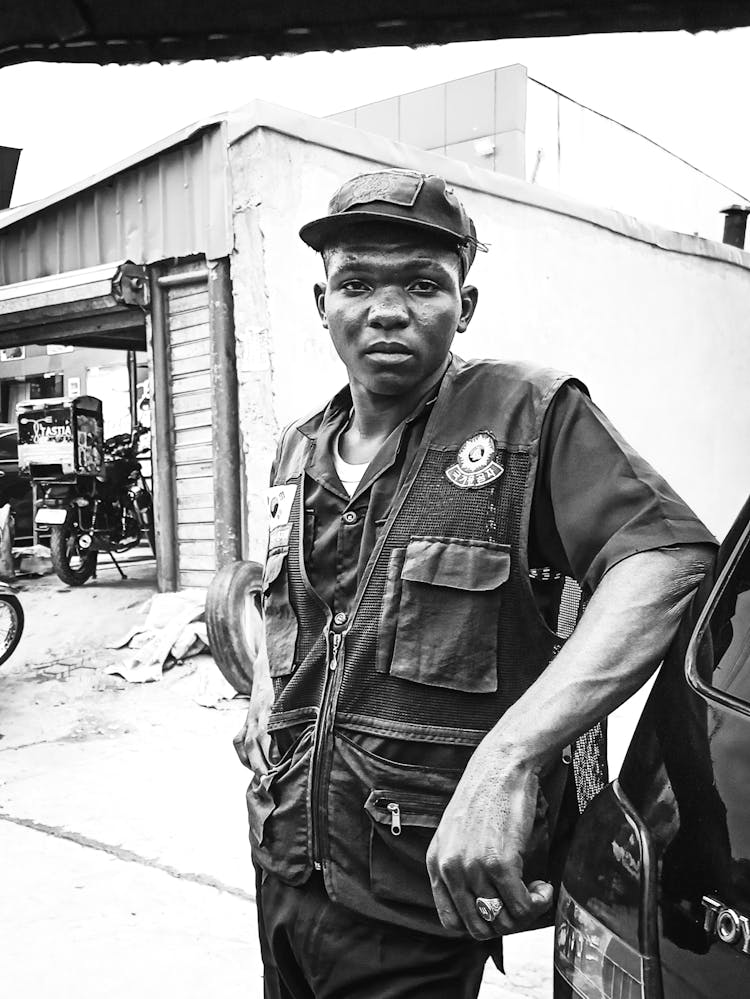 Grayscale Photo Of A Man Vest Uniform