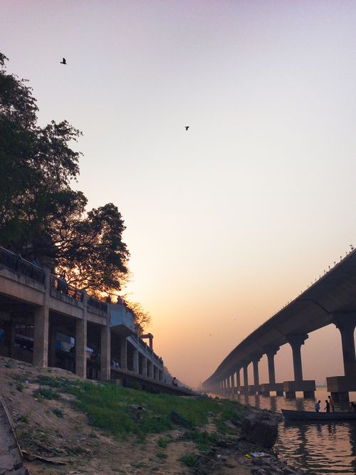 Free Captivating view of a coastal bridge during a serene sunset, perfect for travel imagery. Stock Photo