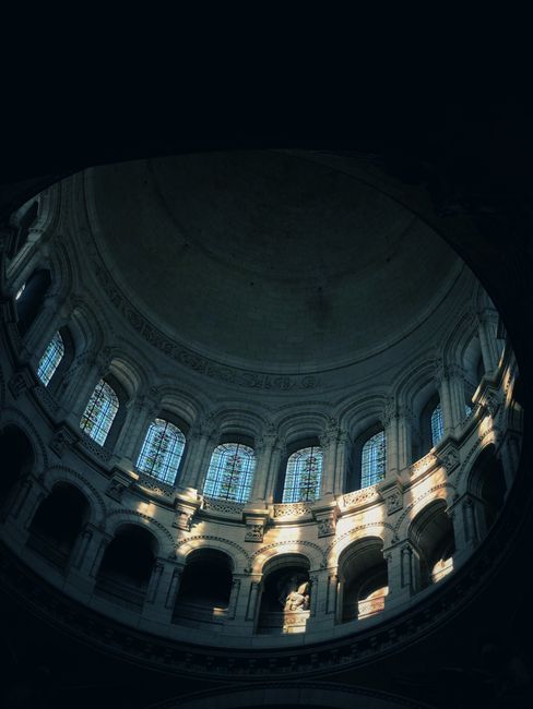 Stunning view of a cathedral dome in France with intricate arches and windows.