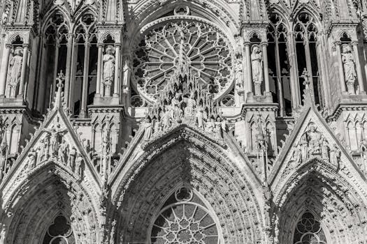 Intricate facade of Reims Cathedral captured in monochrome, highlighting gothic architecture's detailed craftsmanship.