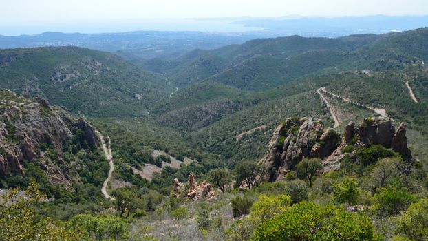 Breathtaking view of lush green valleys and rugged mountains under a clear sky.