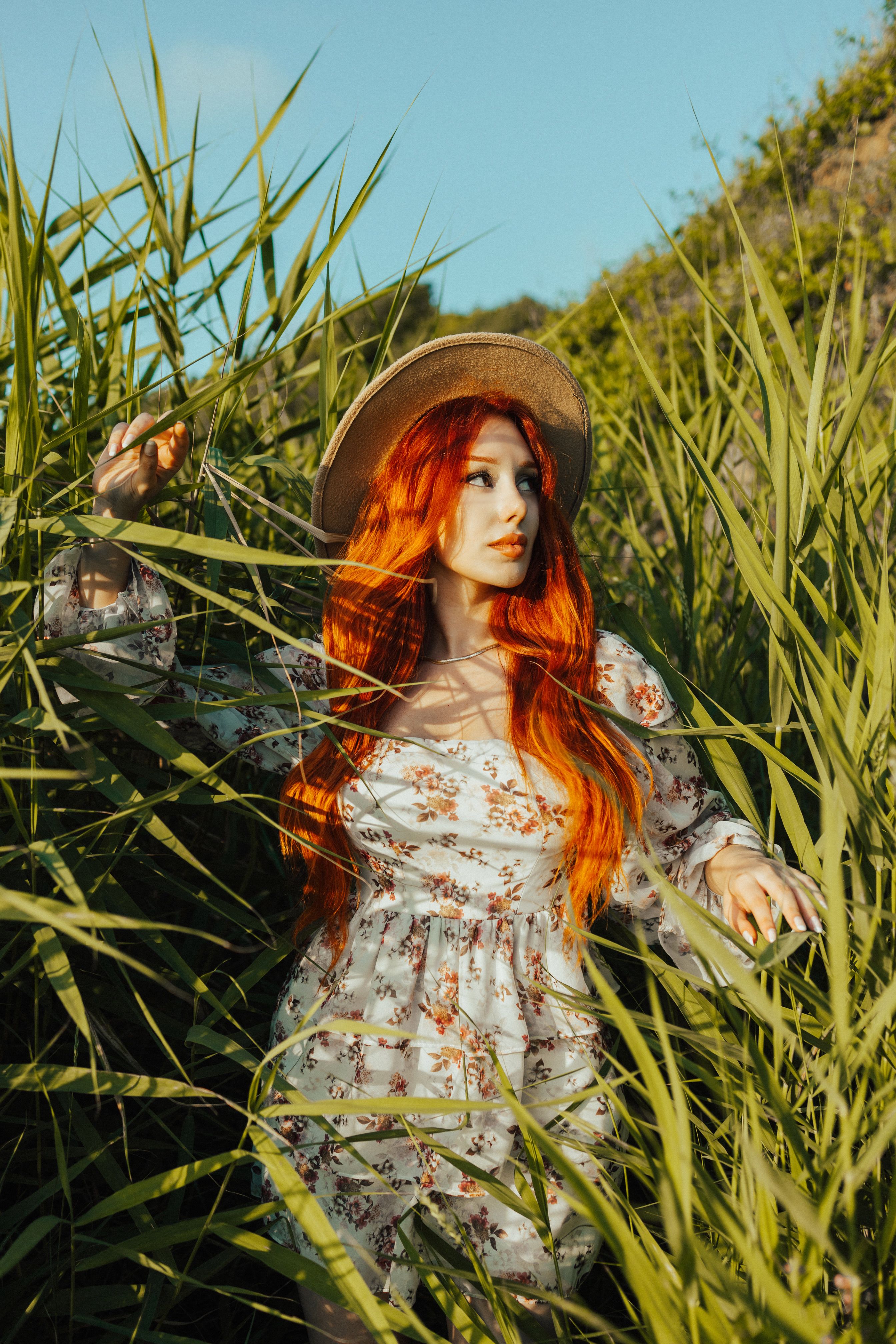 A Redheaded Woman in White Floral Dress on a Grassy Field · Free Stock ...