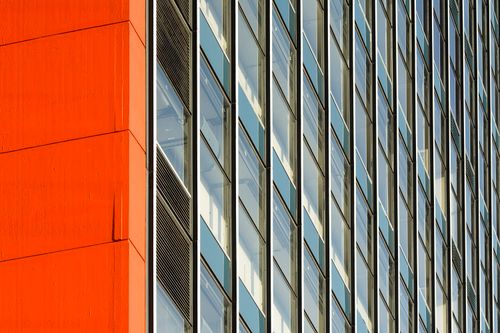 Free A close-up of a modern building's facade featuring geometric windows and bold colors. Stock Photo