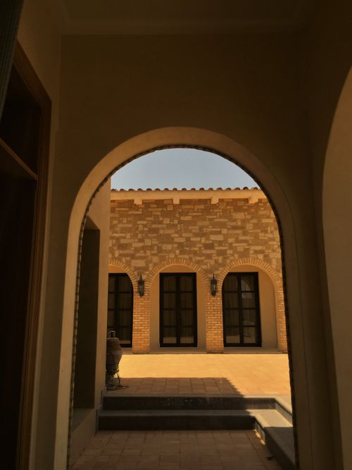 Free Beautiful courtyard view through archway in Hail, Saudi Arabia highlighting traditional architecture. Stock Photo