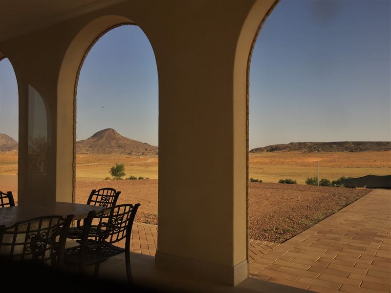 Arched terrace looking out over an open valley at golden hour — photo by Llana on Pexels