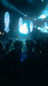Energetic concert scene at night in Istanbul with audience silhouetted by bright stage lights.