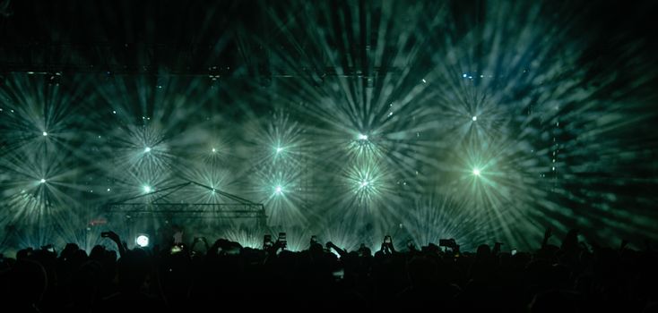 Captivating concert light show with a large crowd in Istanbul at night.