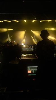 Dynamic night club scene in Istanbul featuring a DJ at the mixer with vibrant lights and an energetic crowd.