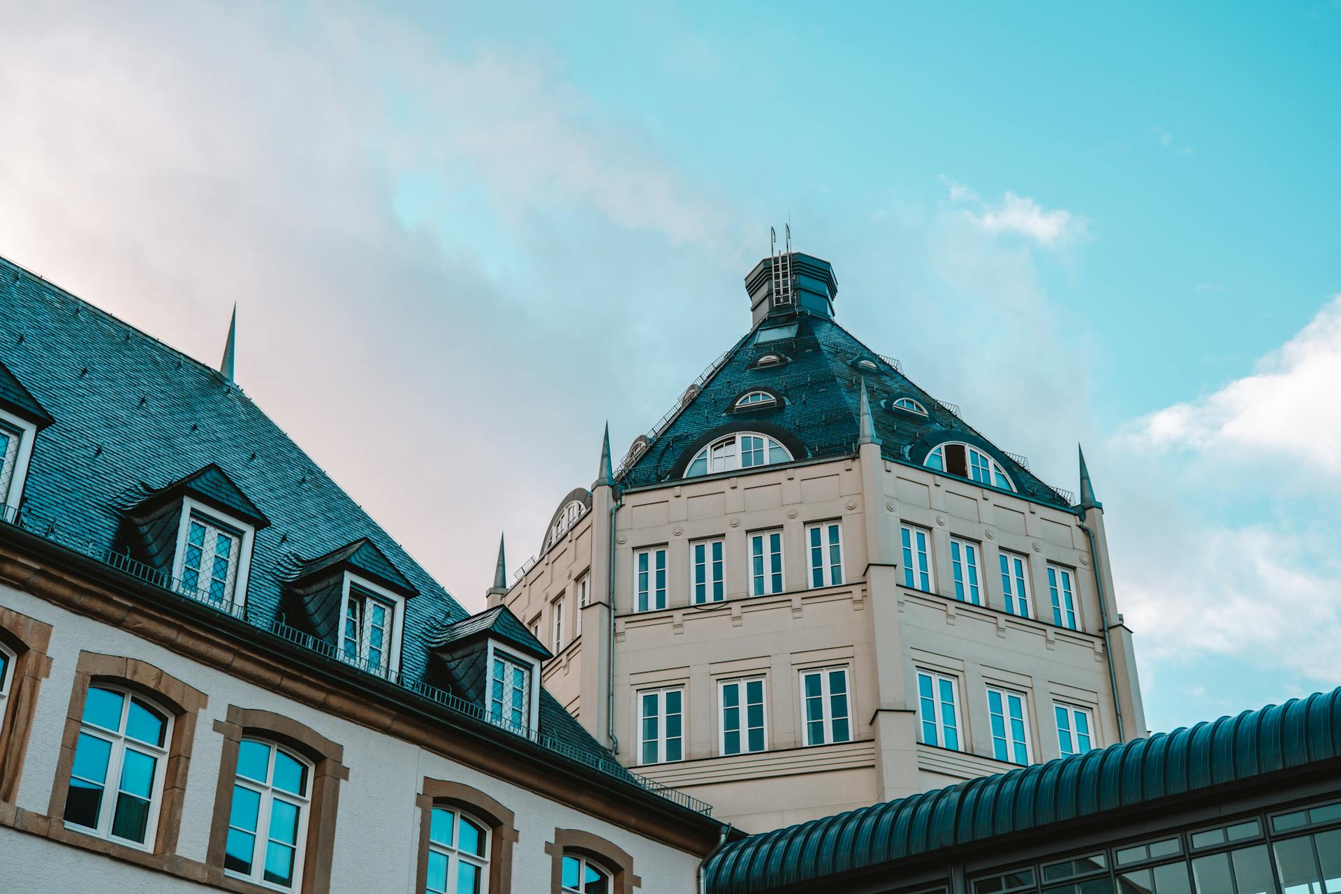 A historic building in Luxembourg stands against a striking blue sky, showcasing its unique architecture.