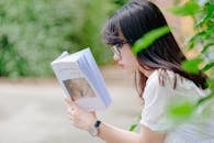 Selective Focus Photo of Woman Reading Book