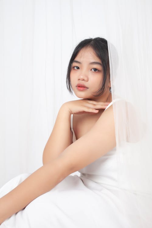 A Girl in White Dress While Posing 