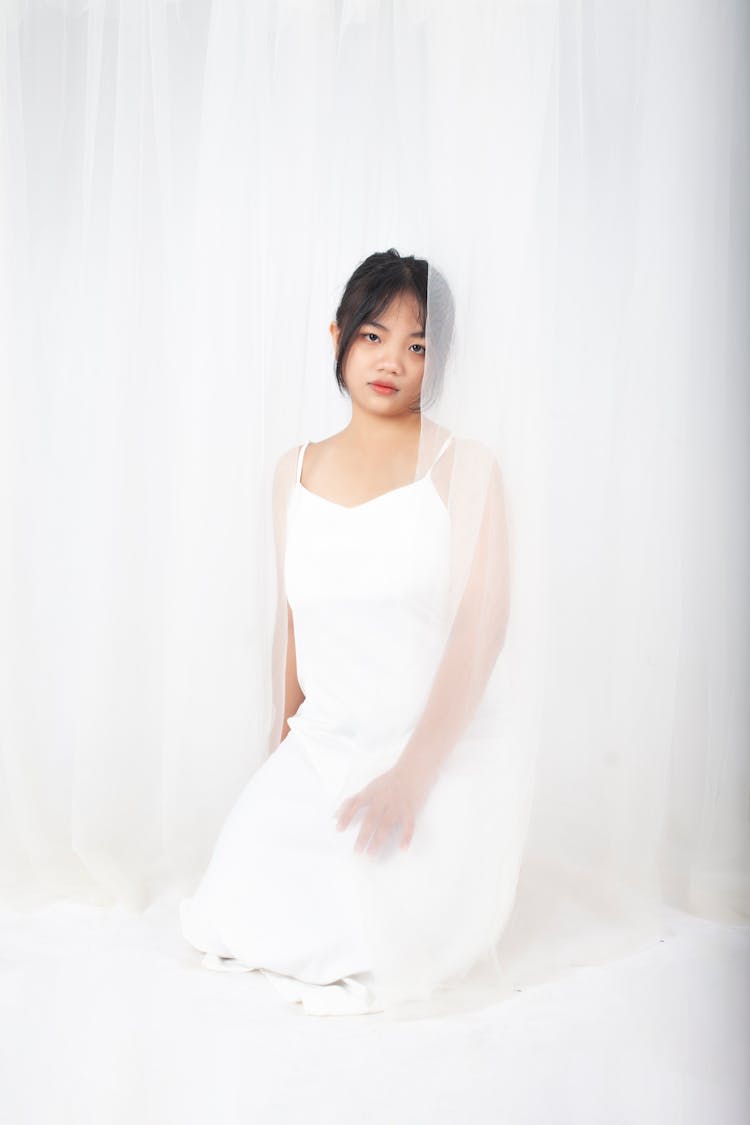 Girl In White Dress Near Curtain 