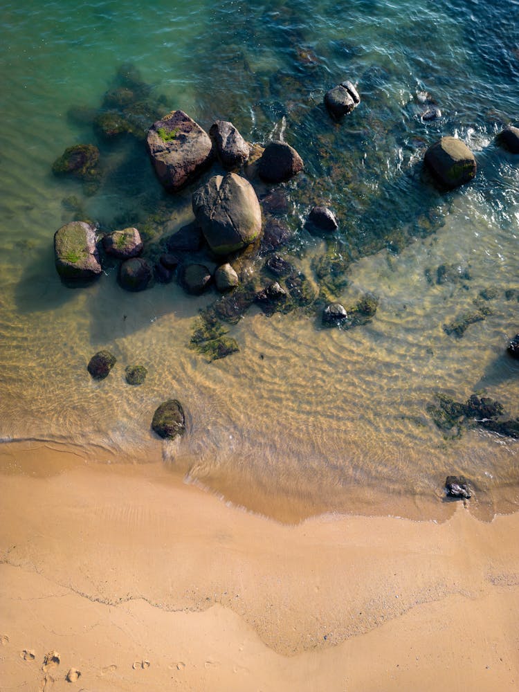 Sandy Beach And Pebbles In The Sea 