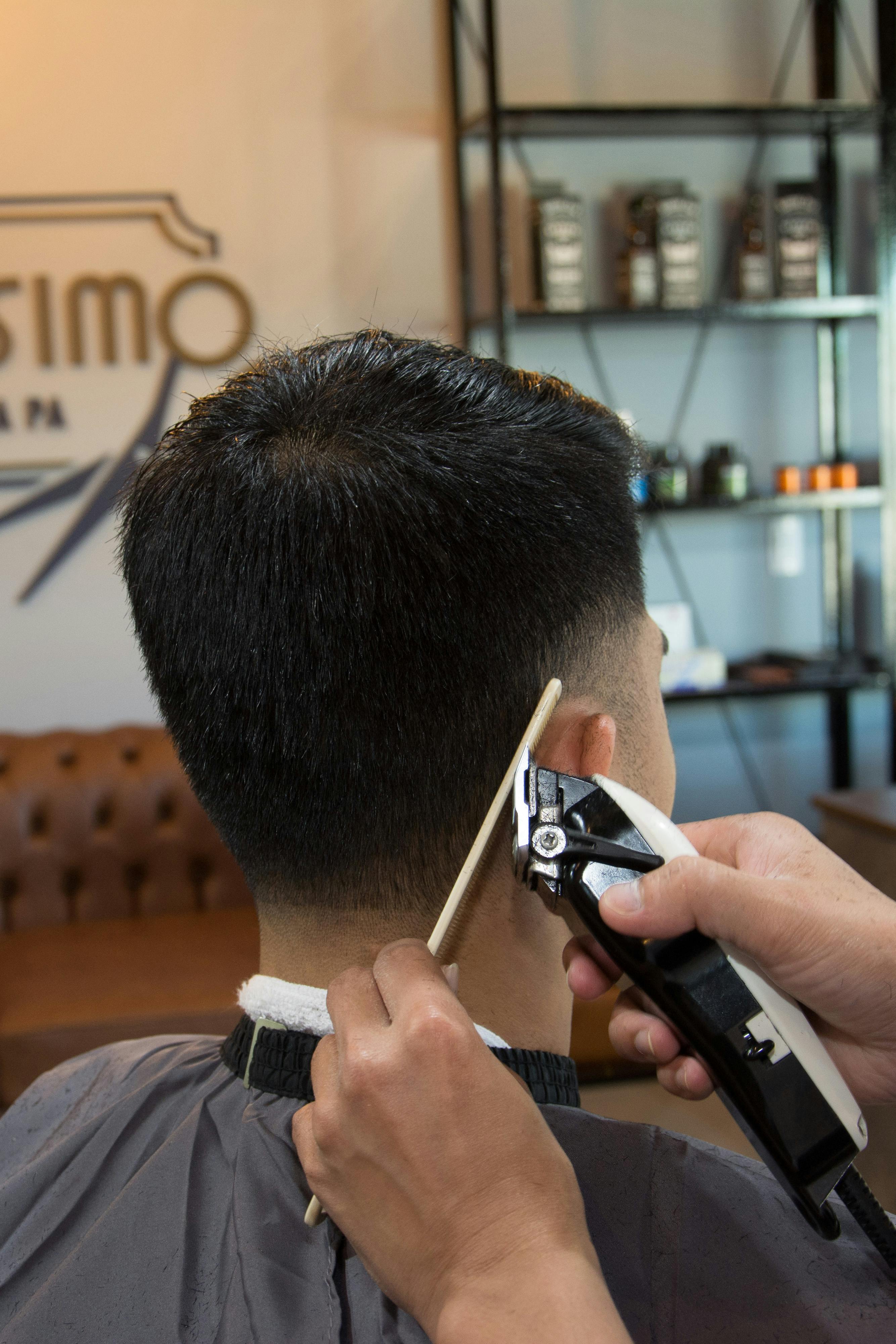 Man Getting His Hair Cut at a Barber Shop · Free Stock Photo