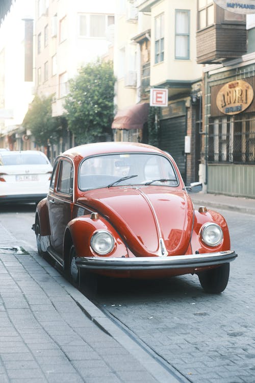 Red Volkswagen Beetle Parked on the Sidewalk