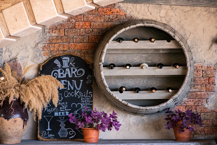 Wine Bottles In Barrel In Bar