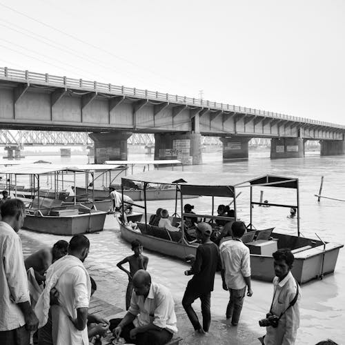 Grayscale Photo of People Riding Wooden Boat