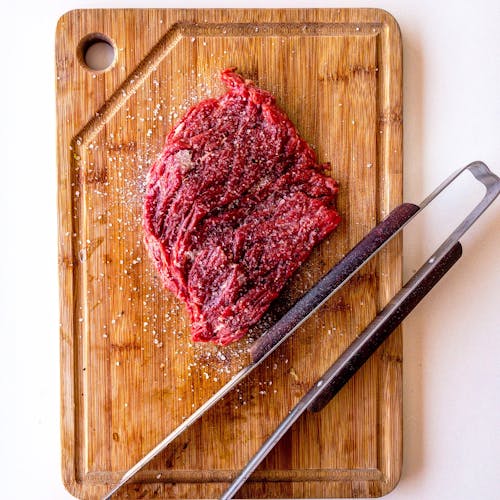 Free Brown Wooden Chopping Board With Meat On Top Stock Photo