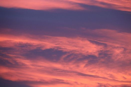 Dramatic sunset sky with vibrant purple and pink clouds, creating a stunning and serene ambiance.