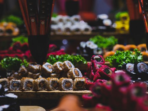 Free A vibrant display of assorted sushi rolls on a wooden tray, showcasing diverse colors and textures. Stock Photo