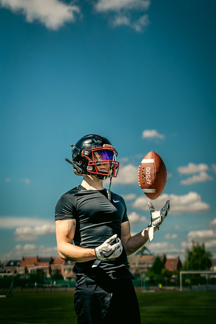 Photo Of A Man In A Black Shirt Tossing A Football