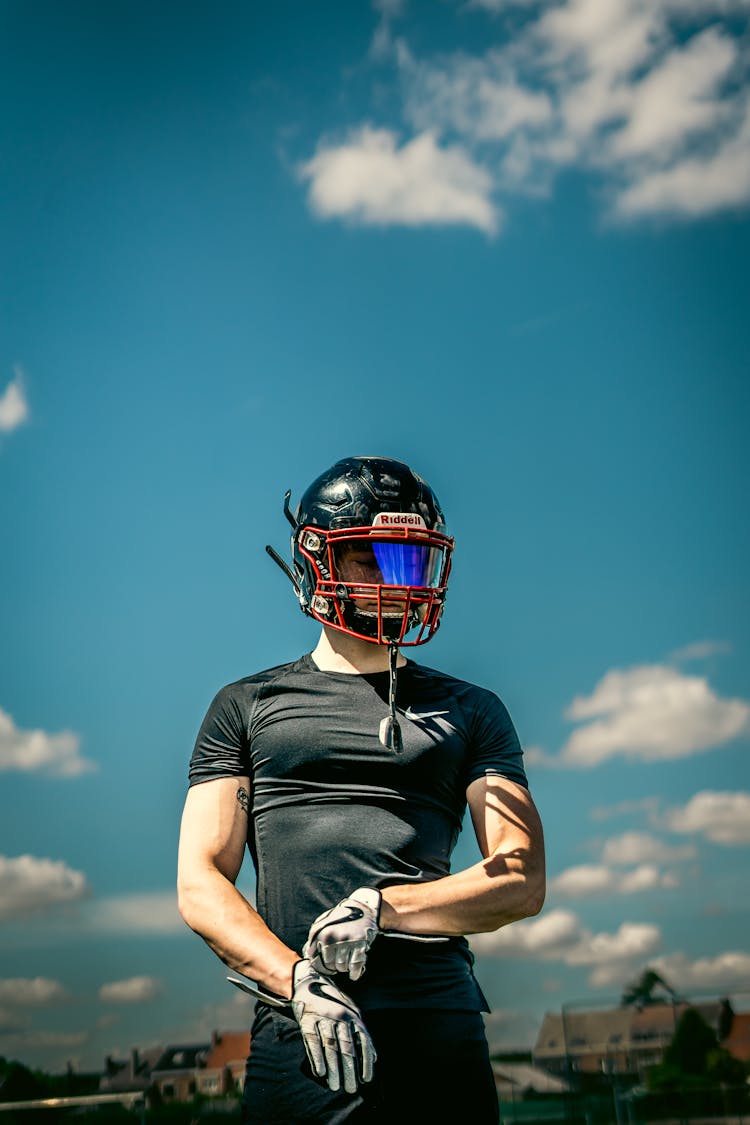 A Football Player Wearing A Helmet 