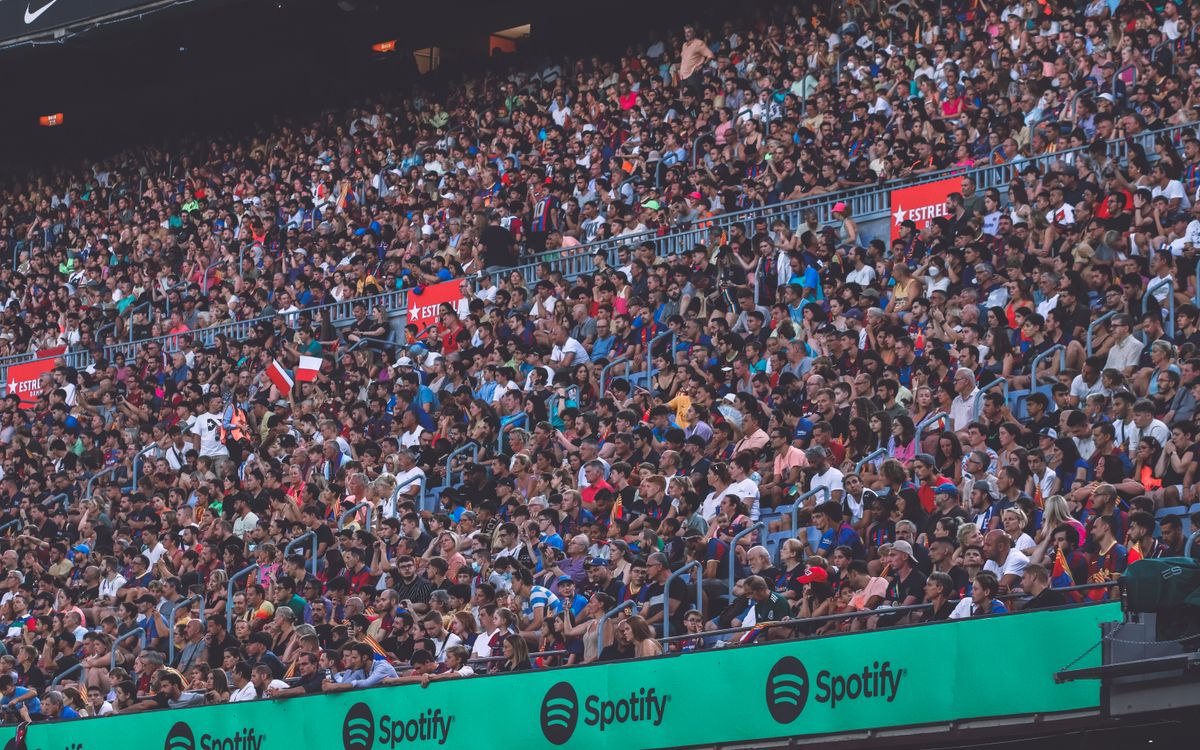 A packed stadium with enthusiastic fans cheering, showcasing diverse spectators.