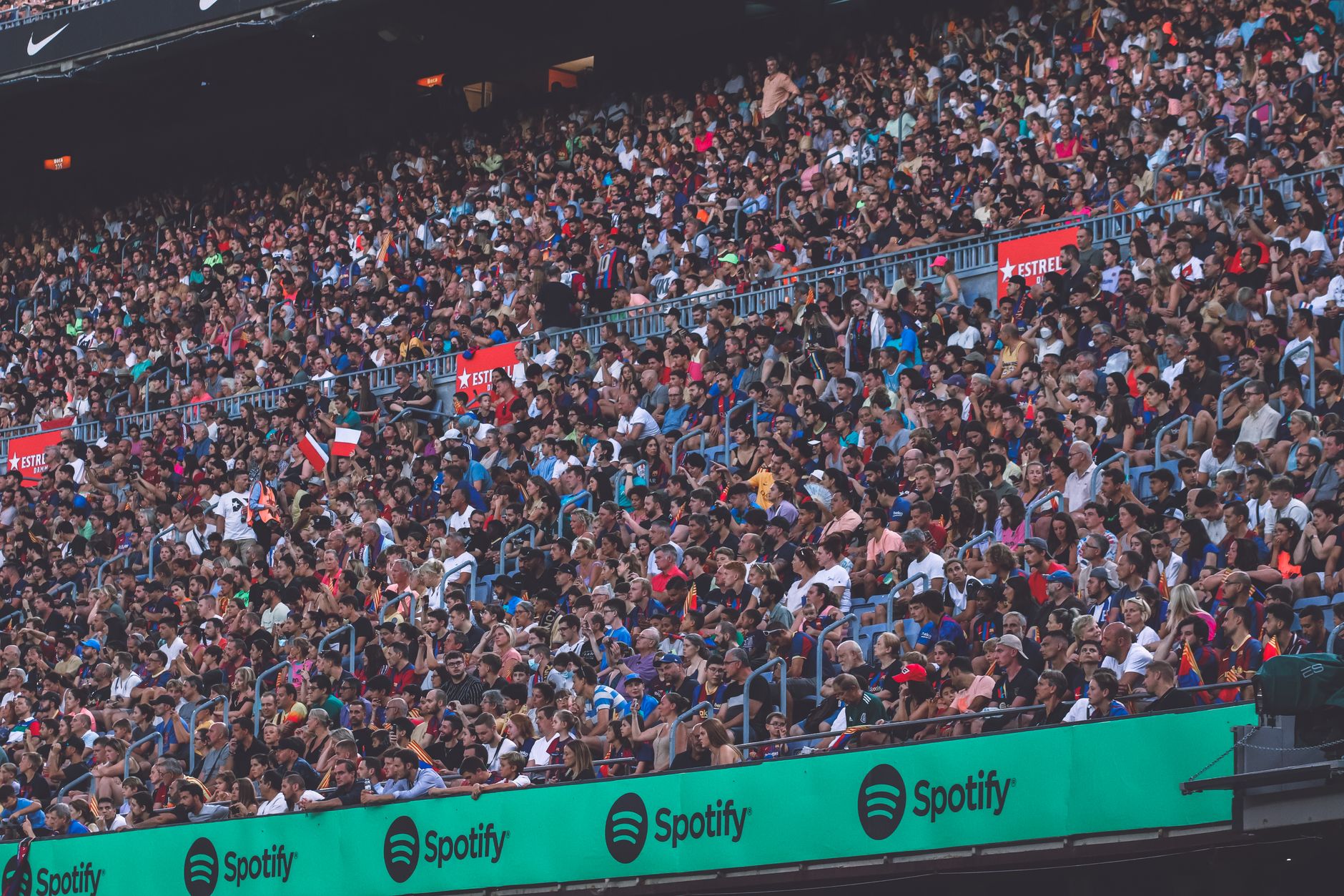NCAA Football photo featuring A packed stadium with enthusiastic fans cheering, showcasing diverse spectators.
