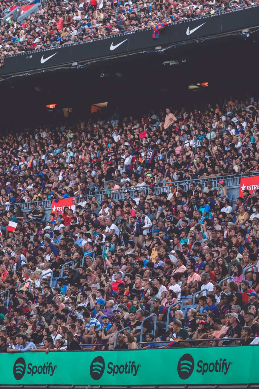 Lively audience fills a Barcelona stadium for a thrilling soccer match.