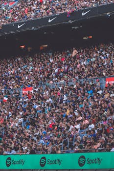 Lively audience fills a Barcelona stadium for a thrilling soccer match.