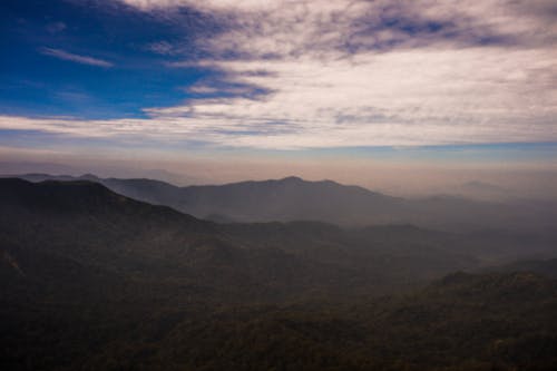 Aerial Photography of Green Mountains under the Cloudy Sky