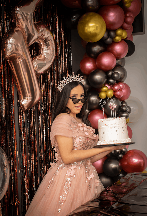 Woman in Princess Costume Holding a Birthday Cake 