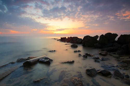 免费 日落期间海上黑岩形成 素材图片