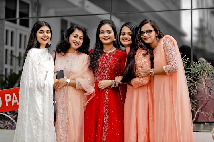 Women In Their Gowns Attending A Wedding