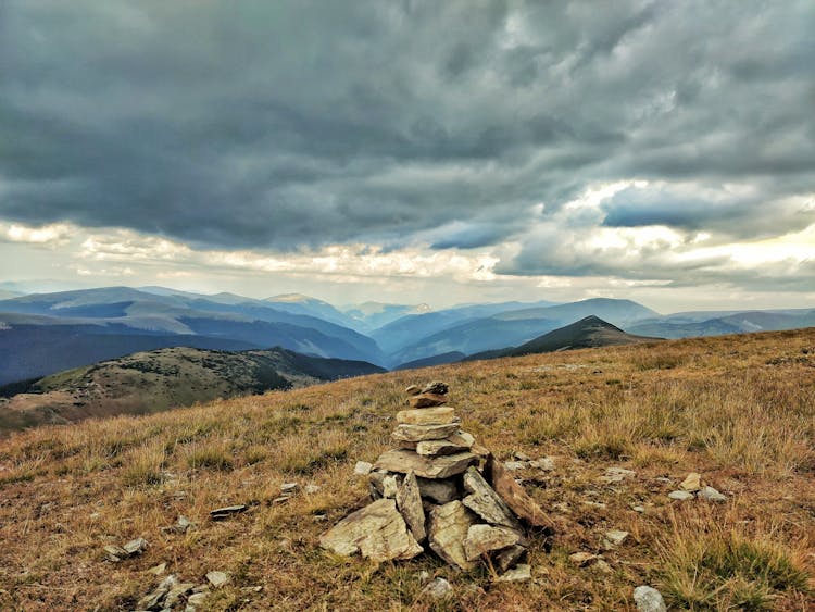 Stack Of Rocks On Brown Field