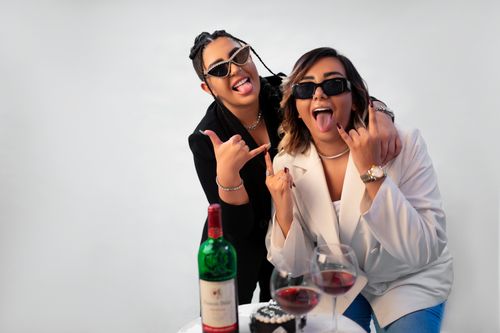 Free Two women enjoy a celebratory moment with wine and a smile in a stylish setting. Stock Photo
