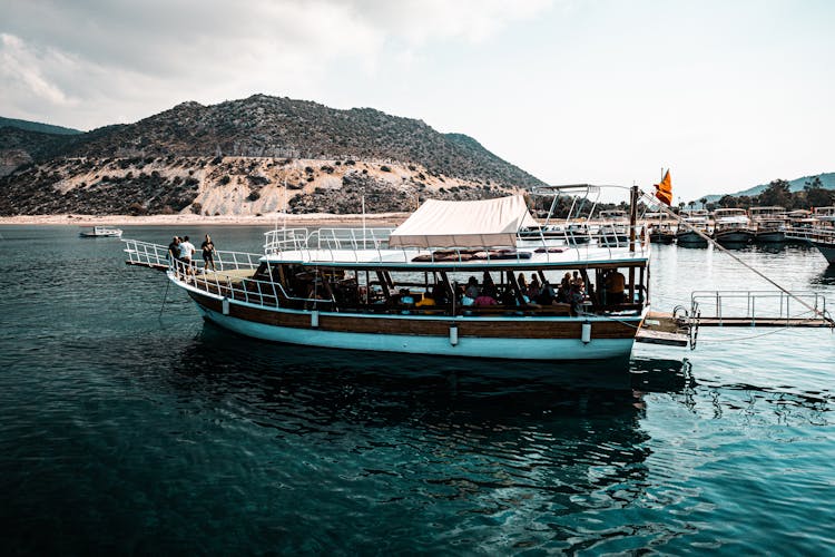 People Riding A Boat On Water