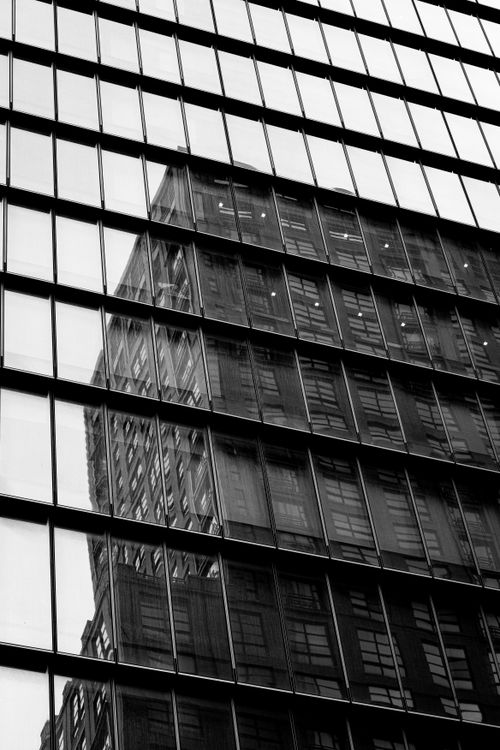 Free Black and white reflection of New York skyscraper on a glass building facade. Stock Photo