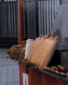 A street vendor displaying grilled corn cobbs. Perfect for food and lifestyle imagery.