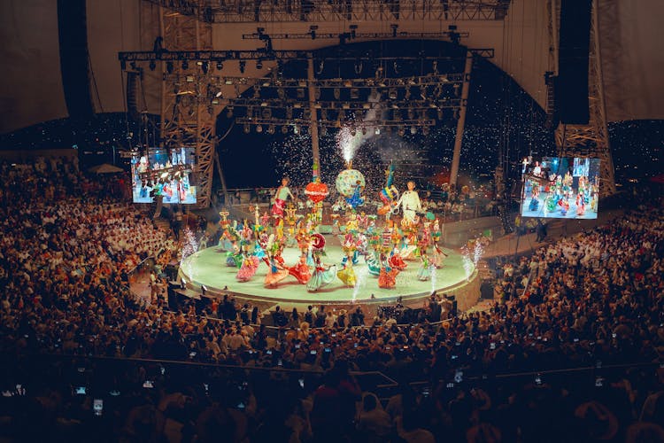 People In Costumes Performing On Stage