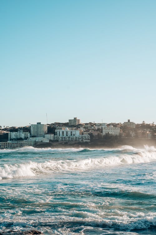 Sea with Huge Waves and the City on the Coast 