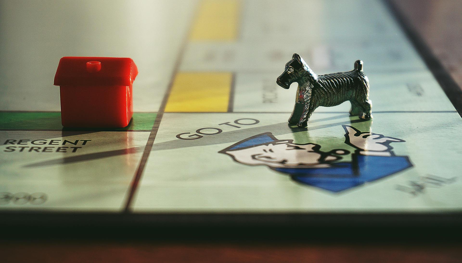 Miniature Toy on Monopoly Board Game