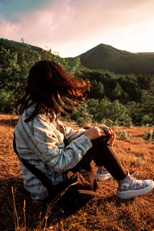 Photo of a Girl Sitting on the Grass