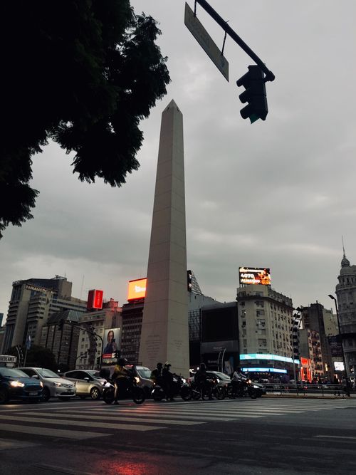Free A dynamic view of the Obelisco de Buenos Aires surrounded by city lights and traffic at dusk. Stock Photo