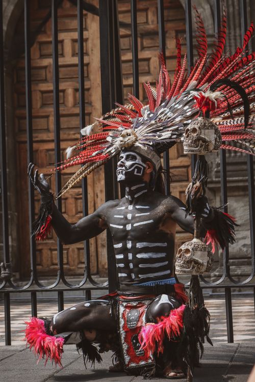 Free Man in tribal costume performing ritual dance in street setting. Stock Photo