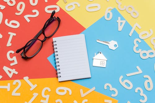 Free Eyeglasses Near Notebook and Metal Key Stock Photo