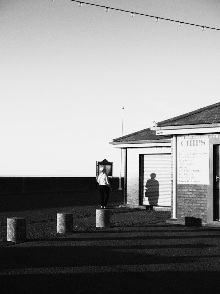 Woman With Her Shadow Cast On The Garage Door 